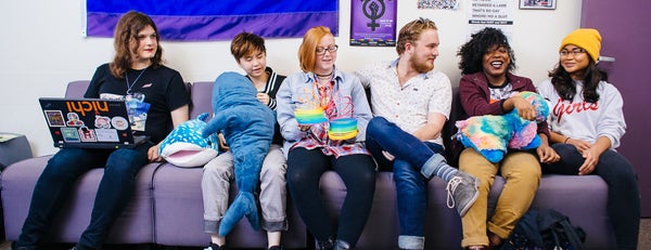 LGBTRC students hanging out on couch in office.