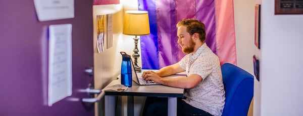 LGBTRC student working on laptop.