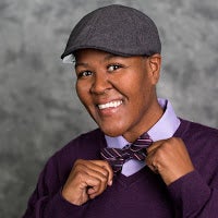 Smiling Toi Thibodeaux in hat and bowtie.