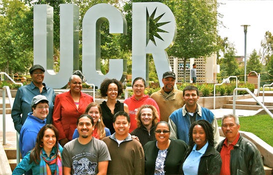 Common Ground Collective members in front of UCR sign.