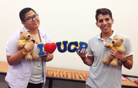 LGBTRC students holding I heart UCR souvenir and stuffed bears.