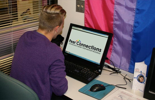 LGBTRC student working on laptop.