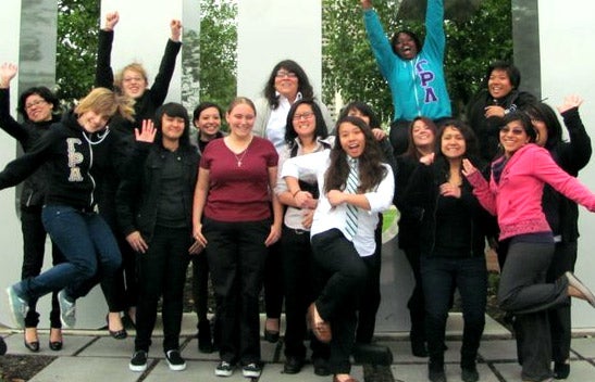 LGBTRC students in front of UCR sign.