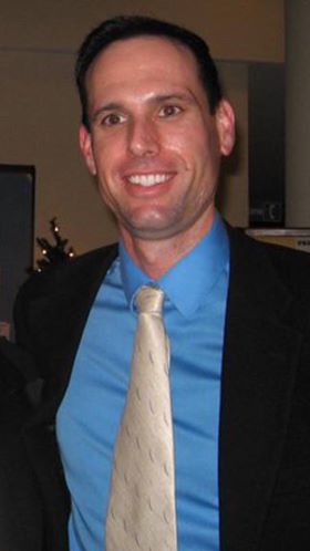 Gene Moynier Gene Moynier in suit and tie.